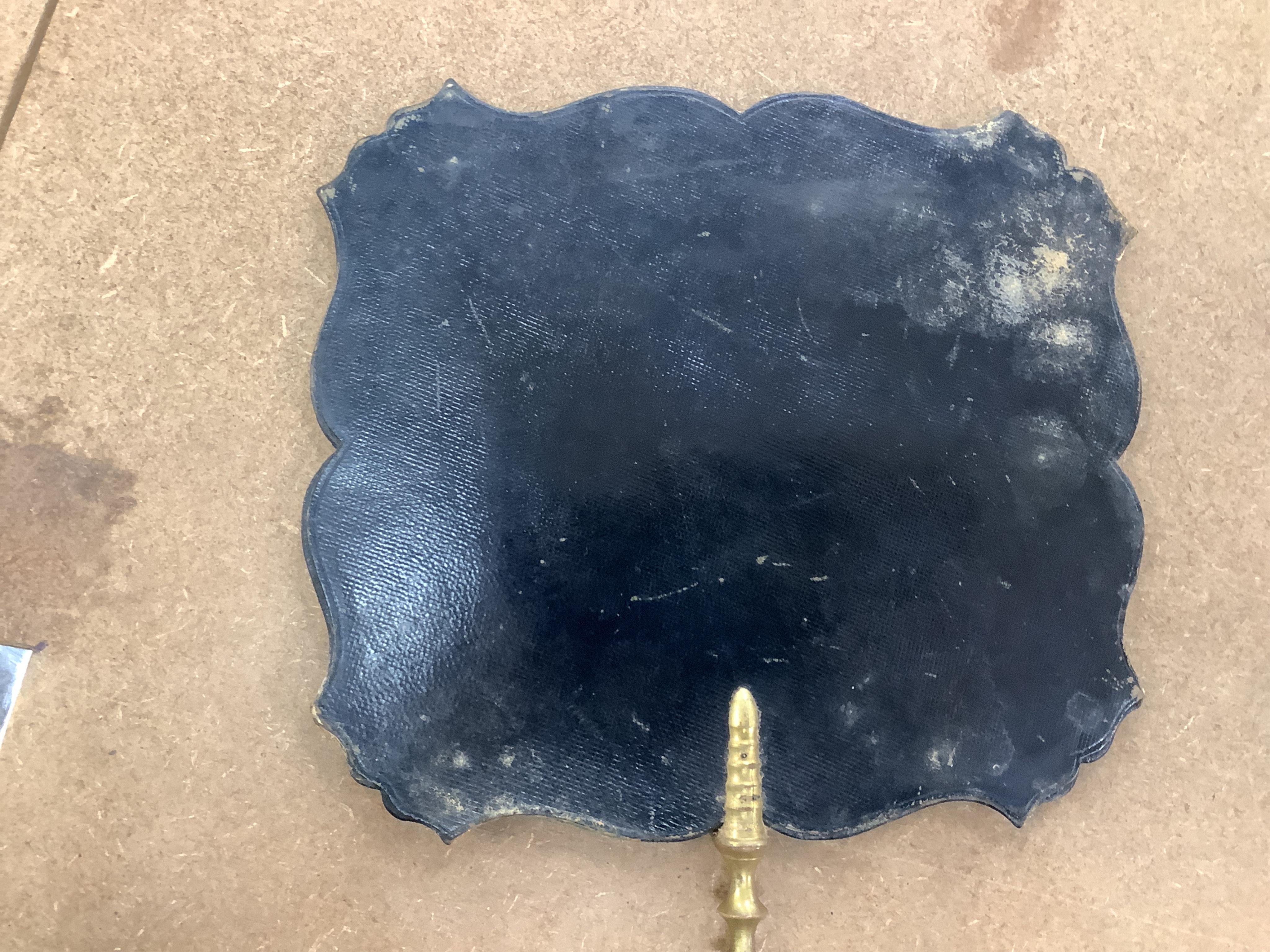 A pair of early Victorian papier maché hand screens, each with embroidered with cross stitched flowers, 41cm in length